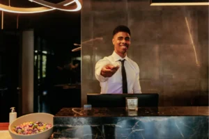 Security guard monitoring surveillance cameras at a front desk